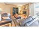 Cozy living room with a stone fireplace, black entertainment center and a door to the outside patio at 66 Goldrush Ne Cir, Atlanta, GA 30328