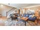 Spacious living room with staircase, featuring hardwood floors, leather sofas, and adjacent dining area at 66 Goldrush Ne Cir, Atlanta, GA 30328