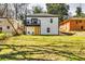 View of the home's backyard, featuring a yellow door and second story balcony at 236 Barfield Sw Ave, Atlanta, GA 30310