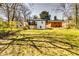 Large backyard with mature trees and view of the house's back porch and exterior at 236 Barfield Sw Ave, Atlanta, GA 30310