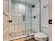 Beautiful tiled shower featuring glass door, rainfall shower head, and modern fixtures at 236 Barfield Sw Ave, Atlanta, GA 30310