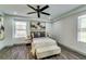 Inviting bedroom with a modern ceiling fan, sleek bedside tables, and wood-style floors at 236 Barfield Sw Ave, Atlanta, GA 30310