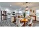 Modern eat-in kitchen featuring white cabinets, stainless steel appliances, and a breakfast bar at 236 Barfield Sw Ave, Atlanta, GA 30310