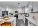 Bright kitchen with stainless steel appliances, white cabinets, quartz counters, and modern fixtures at 236 Barfield Sw Ave, Atlanta, GA 30310