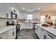 Modern kitchen featuring white cabinets, quartz countertops, stainless steel appliances, and ample counter space at 236 Barfield Sw Ave, Atlanta, GA 30310