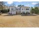 Expansive backyard view of a white home, featuring a deck, patio, and lush lawn at 25 Sherman Nw Ln, Cartersville, GA 30121