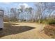 Large, grassy backyard with mature trees, partial shade, and potential for outdoor activities at 25 Sherman Nw Ln, Cartersville, GA 30121