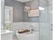 Bright bathroom featuring a standalone tub and glass-enclosed shower at 25 Sherman Nw Ln, Cartersville, GA 30121