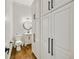 A half bathroom with white cabinets, a sink, toilet, and hardwood floors at 25 Sherman Nw Ln, Cartersville, GA 30121