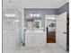 Elegant bathroom with a glass shower and a white vanity with marble floors and blue accent wall at 25 Sherman Nw Ln, Cartersville, GA 30121