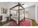 Bedroom with wood framed bed, white walls, plantation shutters, and a colorful rug at 25 Sherman Nw Ln, Cartersville, GA 30121