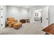 Comfortable bedroom with neutral walls, an armchair with ottoman, and an adjoining room at 25 Sherman Nw Ln, Cartersville, GA 30121