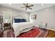 Comfortable bedroom with neutral walls, accent rug, a ceiling fan, and bright windows at 25 Sherman Nw Ln, Cartersville, GA 30121