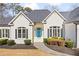 Close up of a charming single-story home with manicured lawn and a bright blue door at 25 Sherman Nw Ln, Cartersville, GA 30121