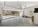 Spacious two-car garage with epoxy flooring, storage cabinets, natural light, and view of the driveway at 25 Sherman Nw Ln, Cartersville, GA 30121