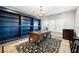 Office with custom built-in blue bookshelves and an ornate wooden desk and light fixture at 25 Sherman Nw Ln, Cartersville, GA 30121