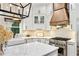 Well-lit kitchen with stainless steel appliances, white cabinets, and a kitchen island at 25 Sherman Nw Ln, Cartersville, GA 30121