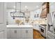 Bright kitchen featuring white cabinets, stainless steel appliances, and a large island at 25 Sherman Nw Ln, Cartersville, GA 30121