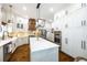 Modern kitchen with white cabinets, an island, stainless steel appliances, and hardwood floors at 25 Sherman Nw Ln, Cartersville, GA 30121