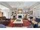 Elegant living room with a crystal chandelier, fireplace, and built-in bookshelves at 25 Sherman Nw Ln, Cartersville, GA 30121