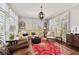A living room area with neutral colors, a large rug, and lots of natural light from the large windows at 25 Sherman Nw Ln, Cartersville, GA 30121