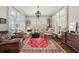 A living room area with neutral colors, a large rug, and lots of natural light from the large windows at 25 Sherman Nw Ln, Cartersville, GA 30121