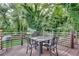 Back deck with four-seat dining table and metal railing at 833 N Grand Nw Ave, Atlanta, GA 30318