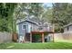 Backyard view featuring a deck and steps with a wood fence surround at 833 N Grand Nw Ave, Atlanta, GA 30318
