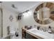 Rustic bathroom featuring a round mirror, decorative light fixture, and shower at 833 N Grand Nw Ave, Atlanta, GA 30318