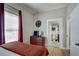 Bedroom with ensuite bathroom, light wood floors, and bright natural light at 833 N Grand Nw Ave, Atlanta, GA 30318