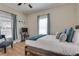 Comfortable bedroom with wood floors, large window, and a cozy bed with plush pillows at 833 N Grand Nw Ave, Atlanta, GA 30318