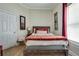 Cozy bedroom featuring a rustic wood bed frame and a window with natural light at 833 N Grand Nw Ave, Atlanta, GA 30318