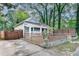 Landscaped front yard enclosed by horizontal and vertical wooden fencing and a paved driveway at 833 N Grand Nw Ave, Atlanta, GA 30318