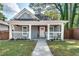 Charming home featuring a welcoming front porch with rocking chairs and well-maintained landscaping at 833 N Grand Nw Ave, Atlanta, GA 30318