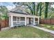 Inviting craftsman-style home with a quaint front porch, landscaped garden, and manicured lawn at 833 N Grand Nw Ave, Atlanta, GA 30318