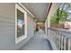 Covered front porch with gray railing, providing a cozy outdoor seating area with a rocking chair at 833 N Grand Nw Ave, Atlanta, GA 30318