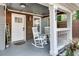 Charming front porch with rocking chairs, creating a welcoming entrance to the home at 833 N Grand Nw Ave, Atlanta, GA 30318