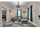 Spacious living room with hardwood floors, ample seating, and a partial view of the kitchen at 833 N Grand Nw Ave, Atlanta, GA 30318