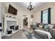 Cozy living room featuring a decorative fireplace, comfortable seating, and hardwood floors at 833 N Grand Nw Ave, Atlanta, GA 30318