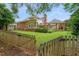 Expansive backyard with lush lawn, brick home, patio area, and a charming gazebo perfect for outdoor gatherings at 155 Oakpark Ct, Mcdonough, GA 30253