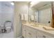 Cozy bathroom with patterned wallpaper, white vanity, and neutral tile flooring at 155 Oakpark Ct, Mcdonough, GA 30253