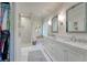 Luxury bathroom with double vanity, marble countertops, and glass enclosed shower at 155 Oakpark Ct, Mcdonough, GA 30253