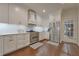 Modern kitchen with stainless appliances, white cabinets, and hardwood floors at 155 Oakpark Ct, Mcdonough, GA 30253