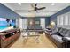 Comfortable living room with blue walls, ceiling fan, wood floors, and two leather sofas perfect for relaxing and entertaining at 155 Oakpark Ct, Mcdonough, GA 30253