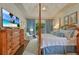 Serene main bedroom with four-poster bed, sitting area, and tray ceiling at 155 Oakpark Ct, Mcdonough, GA 30253