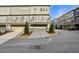 Street view of townhomes with garages and well-maintained landscaping at 1828 Falling Sky Ct, Atlanta, GA 30319