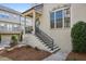 Charming exterior of a two-story townhome, featuring brick and hardiplank accents, professional landscaping, and covered entry at 1828 Falling Sky Ct, Atlanta, GA 30319