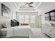 A main bedroom with a tray ceiling, large windows, neutral carpet and paint, and a closet and dresser at 1828 Falling Sky Ct, Atlanta, GA 30319