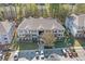 Aerial view of a well-maintained apartment building with parking, landscaping, and traditional architectural details at 2201 Fairington Village Dr, Lithonia, GA 30038