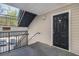 Apartment entrance with a black door, stairs, and railing to the left, with parking visible at 2201 Fairington Village Dr, Lithonia, GA 30038